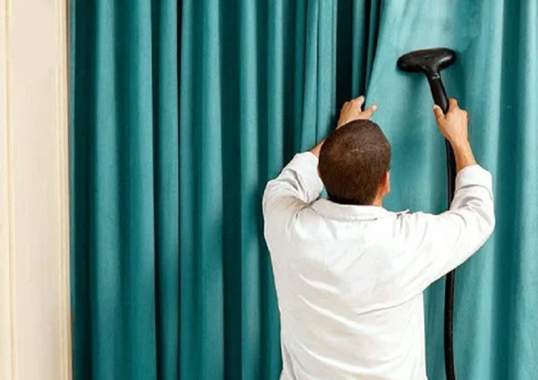 Professional steam cleaning a curtain