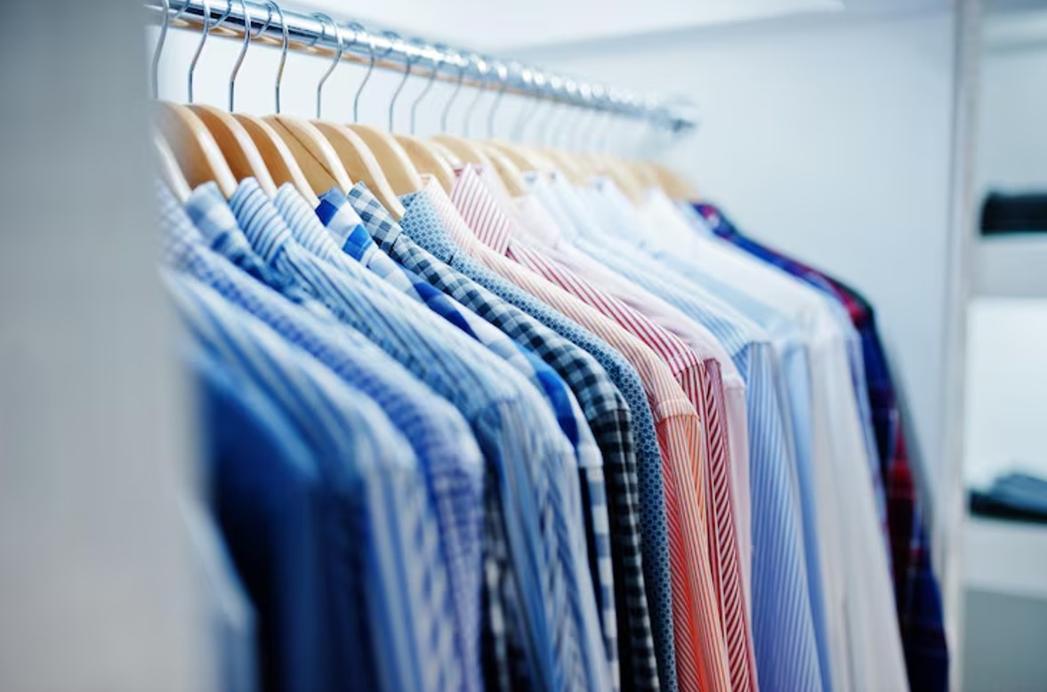 Freshly dry cleaned shirts hanging on a rack